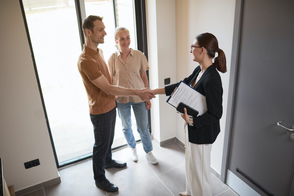 Couple Greeting Real Estate Agent